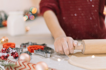 Obraz na płótnie Canvas Closeup view of cookie cutters, dough and Christmas lights