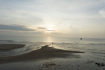 Beautiful dawn, morning sun rises by the sea. Scenic beach, coastline, rocks, cloudscape and skyline photography. Sunrise during the early hours of a summer morning by the beach. Sunset by the beach.