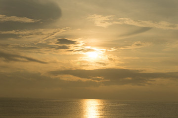 Beautiful dawn, morning sun rises by the sea. Scenic beach, coastline, rocks, cloudscape and skyline photography. Sunrise during the early hours of a summer morning by the beach. Sunset by the beach.