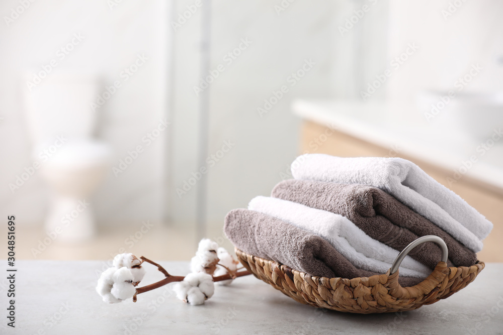 Canvas Prints Basket with fresh towels on table in bathroom