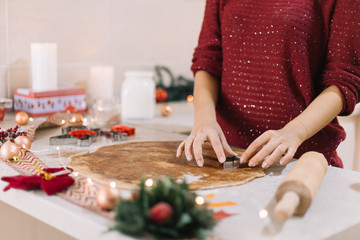 Christmas tree-shaped metal cutter on gingerbread dough