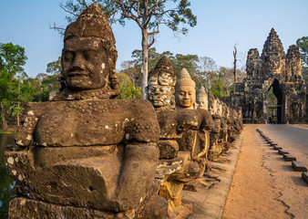 Travel concept. Row of sculptures in the South Gate of Angkor Thom complex. Location: Siem Reap, Cambodia. Beauty world.
