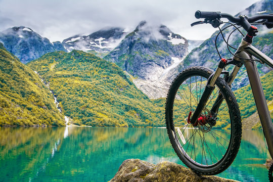 Mountain bike on the background on amazing Norway landscape. Artistic picture. Beauty world.
