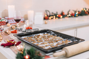 Side view of oven tray with gingerbread cookies for Christmas.