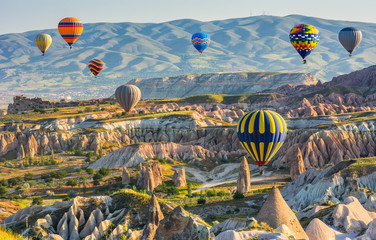 Travel concept. The great tourist attraction of Cappadocia - balloon flight. Cappadocia is known around the world as one of the best places to fly with hot air balloons. Goreme, Cappadocia, Turkey.  B