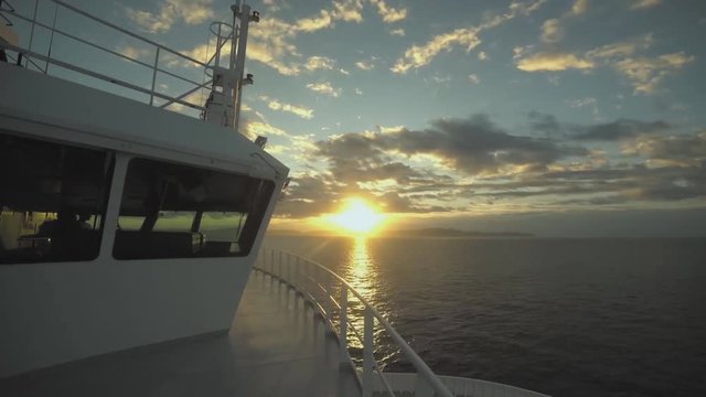 Reflection over the window of a beautiful sunset over Harbour Island from a luxury mega Yacht in Bahamas (time-lapse)