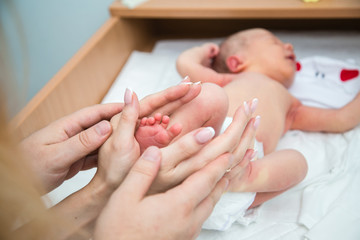 mother holding her babys feet