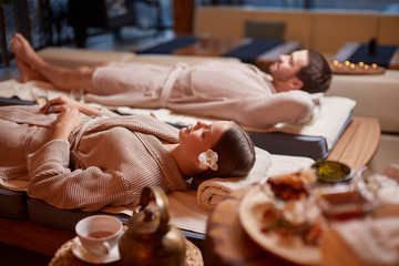Young caucasian husband and wide take pleasure, take rest together in spa center, relax and rest of whole body