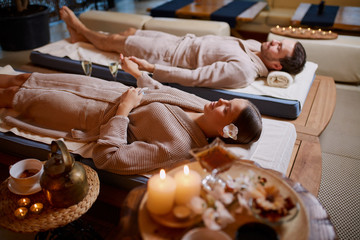 young man and woman, couple in love relaxing together at spa salon, after enjoying treatment, health and body care, holiday weekend
