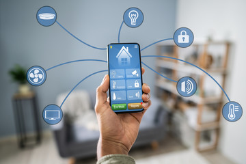 Man Using Home Control System On Cellphone