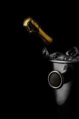 Champagne bottle and ice bucket on black background - 304858434