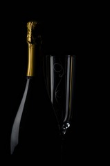 Champagne bottle and glass on black background - 304858483