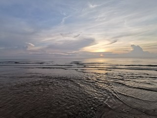 Beautiful dawn, morning sun rises by the sea. Scenic beach, sea, ocean, coastline, rocks, sands, cloudscape and skyline photography.