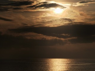 Beautiful dawn, morning sun rises by the sea. Scenic beach, sea, ocean, coastline, rocks, sands, cloudscape and skyline photography.