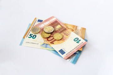 Euro coins lie on the table. European currency on a white background. Various denominations of euro.