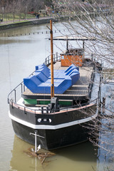 boat docked on the river side, river Bega in Timisoara