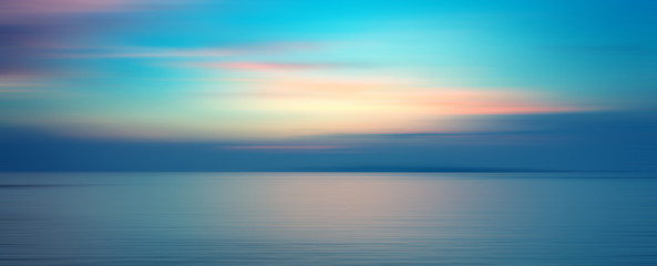 Motion blurred background of sunset on the sea
