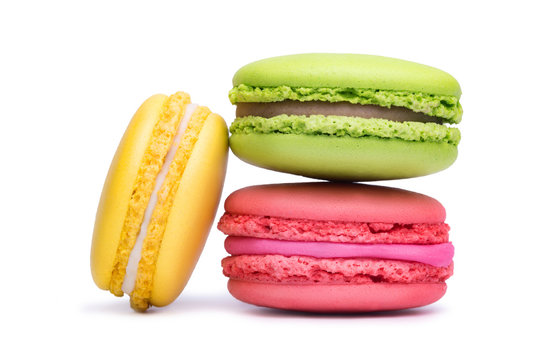 Yellow, pink and green macaron cookies isolated on white background