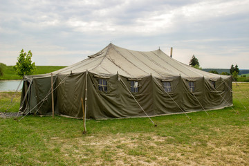 military tent in the the open countryside meadow