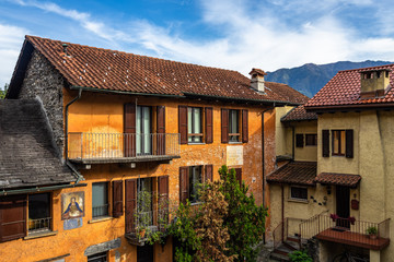 Typical colorful houses lined along a courtyard in Locarno historic center, Canton Ticino, Switzerland