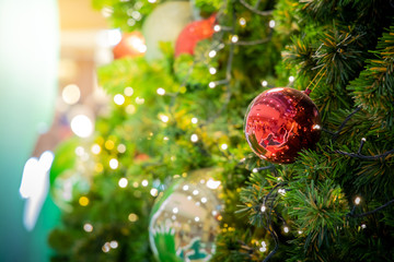 Gold Christmas background of de-focused lights with decorated tree