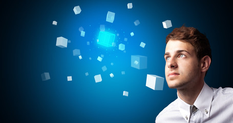 Man touching hologram screen displaying cube symbols