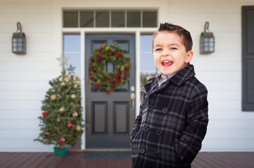 Young Mixed Race Boy On Front Porch of House with Christmas Decorations