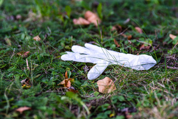 white glove center litter green meadow waste thrown away closeup landscape