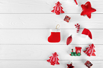 Different christmas objects lay out on white wooden background