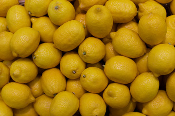 Ripe yellow lemons fruits, backdrop background. Lemons in the supermarket