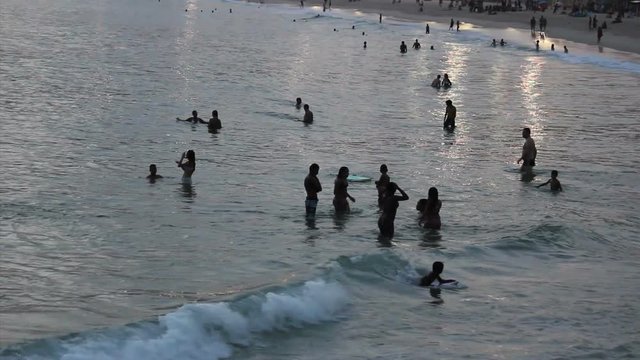 Silhouettes of brazilians enjoying sunset at the beach - Ipanema, Rio de Janeiro