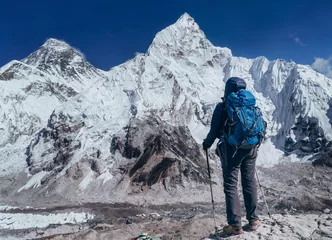 Acrylic prints Mount Everest Young hiker backpacker female taking brake in hike walking enjoying Khumbu Glacier. Everest Base Camp route near Gorakshep,Nepal. Everest mount 8848m (left) and Nuptse 7861m (right) on background.