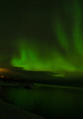 green northern lights aurora borealis in night sky