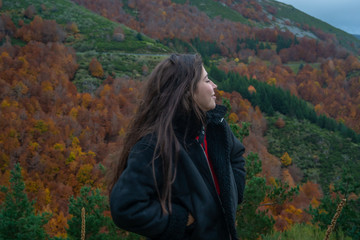 young girl enjoying the autumn landscape
