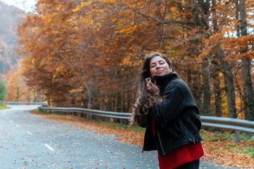 young girl on the road with autumn views
