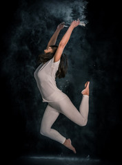 young girl doing yoga poses using powder