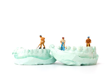Miniature people : Worker team repairing a tooth ,Healthcare and medical concept