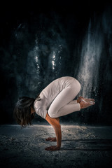 young girl doing yoga poses using powder