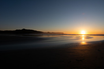 sunset on a sandy beach in tofino