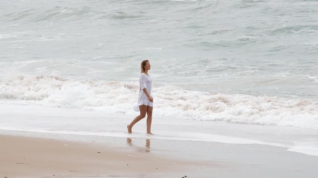 Walk over a sandy beach - sexy girl on holiday - travel photography