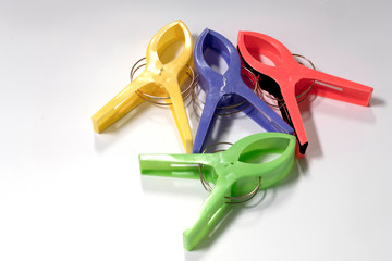 Four large cloth clamps in various colors on a white background.