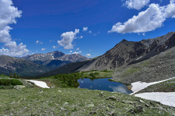 A small alpine lake high up in the Rockies with the summit of Mt. Yale looming in the background.