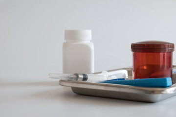 First aid kit placed in the tray and on the table behind the white background.
