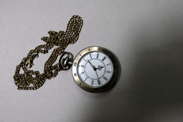 The watch carries an antique bag placed on a black background.
