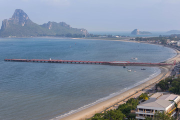 Aerial view of Ao Prachuap bay with Saranwithi bridge stretching in to the sea from Khao Chong Krajok viewpoint at Prachuap khiri khan province Thailand on after noon time. 
