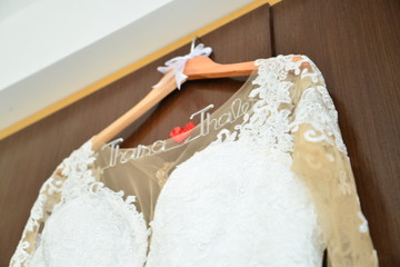 wedding dress hanging on hanger with bride and groom's name, wedding dress, Wife's day	