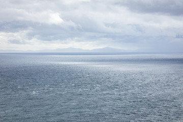 Naklejka na ściany i meble Waves breaking on coastal cliffs of Scotland.
