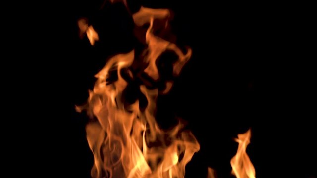 Slow motion shot of fire on a black background to use it transparent in every shot.
