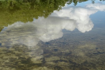 Reflection of sky and clouds in Florida river