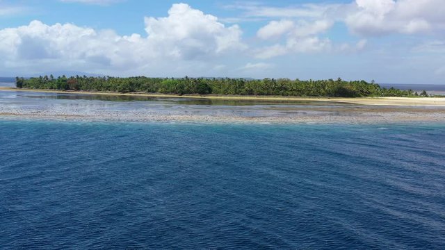 The idyllic, tropical island of Koon, in the Ceram Sea, is surrounded by a large, seagrass-covered reef flat. The dramatic reefs around this remote island are full of schooling fish and corals.